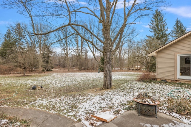 yard covered in snow featuring a fire pit