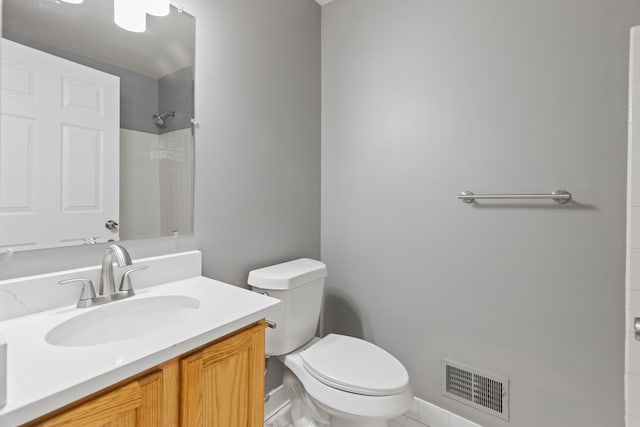 bathroom featuring a shower, vanity, and toilet