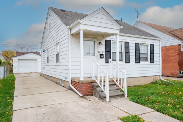 bungalow-style house with an outbuilding, a front lawn, and a garage