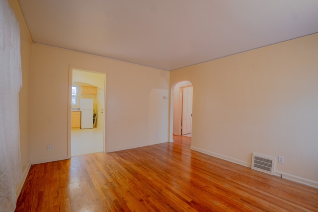 spare room featuring light wood-type flooring