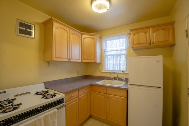 kitchen featuring light brown cabinets, white appliances, and sink