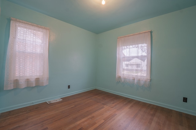 unfurnished room with hardwood / wood-style floors