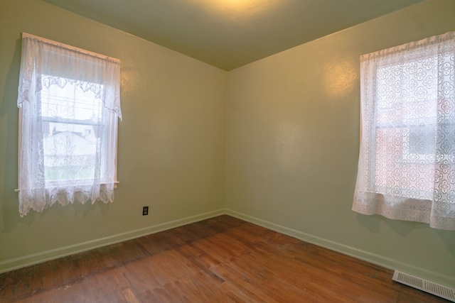 unfurnished room featuring dark hardwood / wood-style flooring