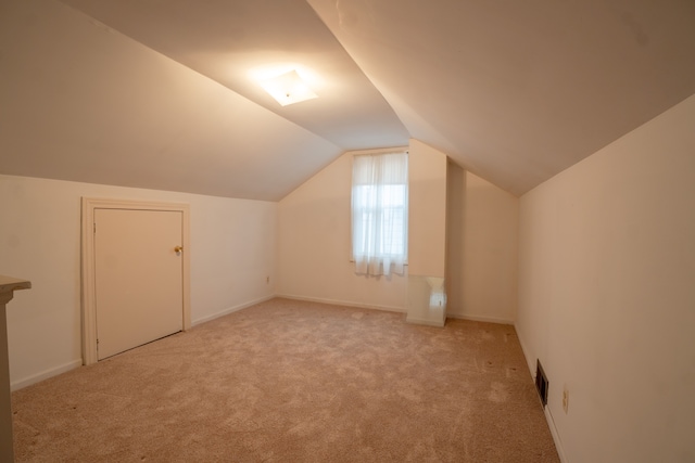 bonus room featuring light colored carpet and lofted ceiling