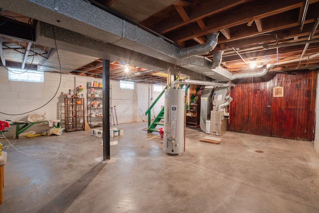 basement featuring heating unit and water heater