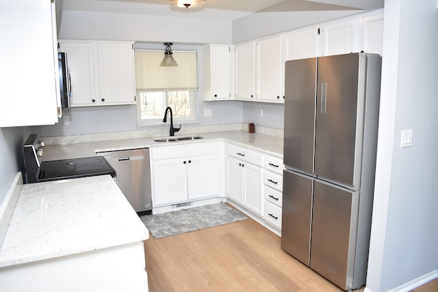 kitchen featuring sink, white cabinets, light hardwood / wood-style flooring, and appliances with stainless steel finishes