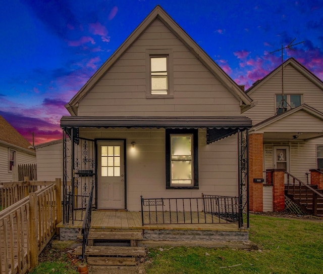 bungalow-style house featuring a yard and a porch