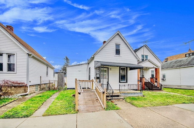 bungalow-style house featuring a front lawn