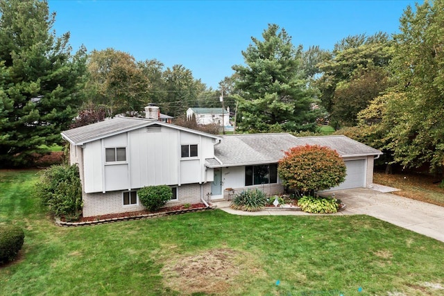 tri-level home featuring a garage and a front lawn