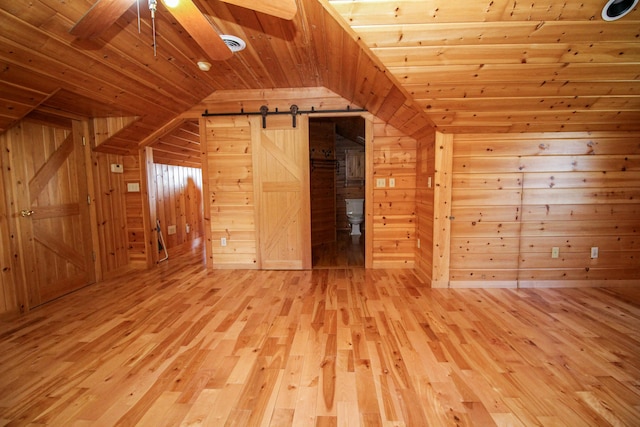 bonus room featuring lofted ceiling, wood-type flooring, wooden ceiling, and wooden walls