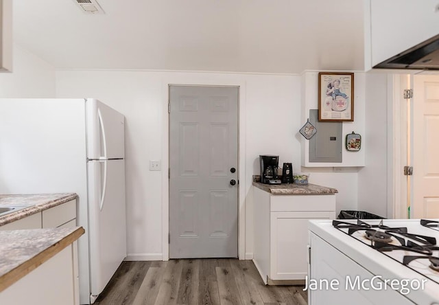 kitchen featuring white appliances, white cabinetry, electric panel, and light hardwood / wood-style flooring