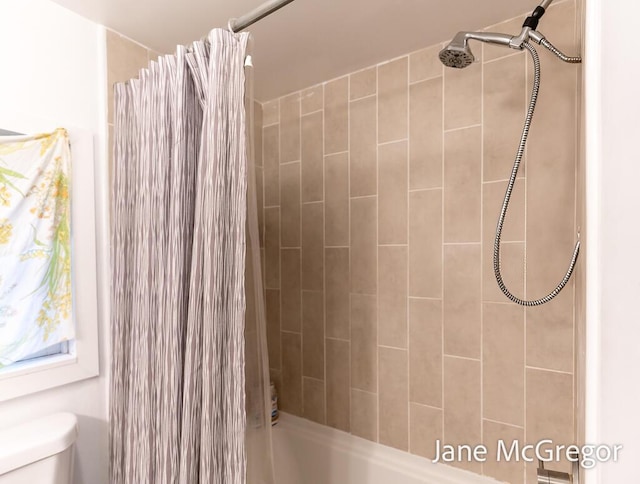 bathroom featuring shower / bath combo and toilet