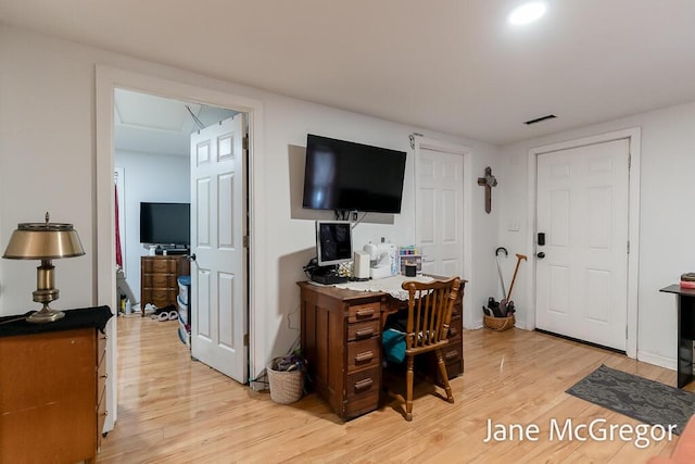 office with light hardwood / wood-style floors