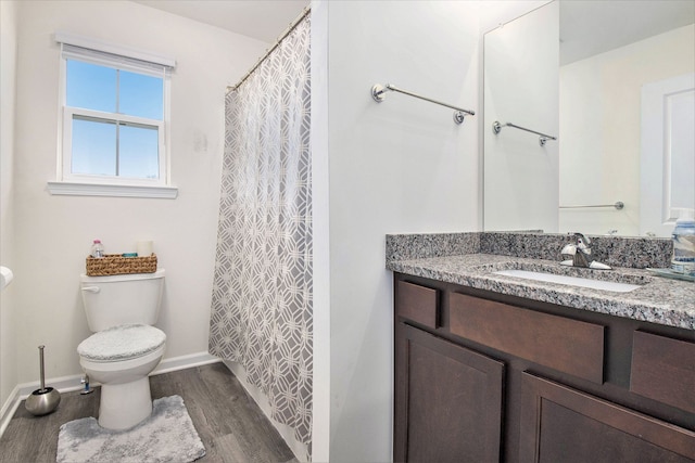 bathroom featuring vanity, toilet, and wood-type flooring