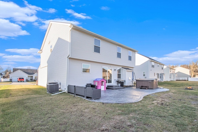 rear view of property with a lawn, a patio area, cooling unit, and a hot tub