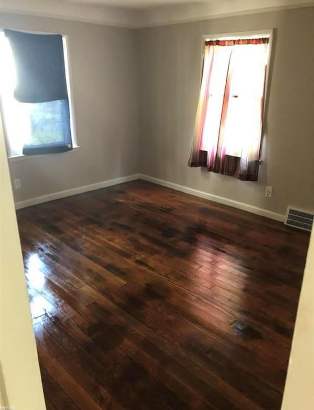 unfurnished room with dark hardwood / wood-style floors