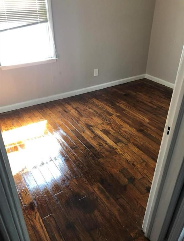 spare room featuring dark hardwood / wood-style floors