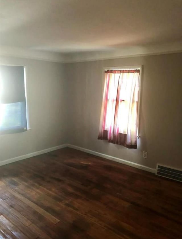 empty room with dark wood-type flooring