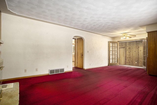 carpeted empty room featuring a textured ceiling, ceiling fan, and ornamental molding