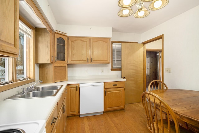 kitchen with dishwasher, light hardwood / wood-style flooring, and sink