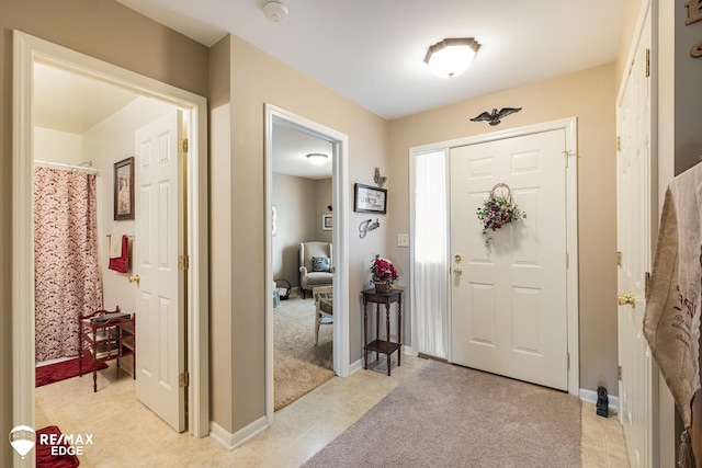 entrance foyer featuring light carpet