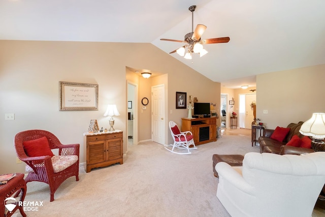 carpeted living room with ceiling fan and lofted ceiling