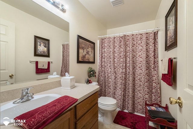 bathroom featuring tile patterned floors, vanity, and toilet