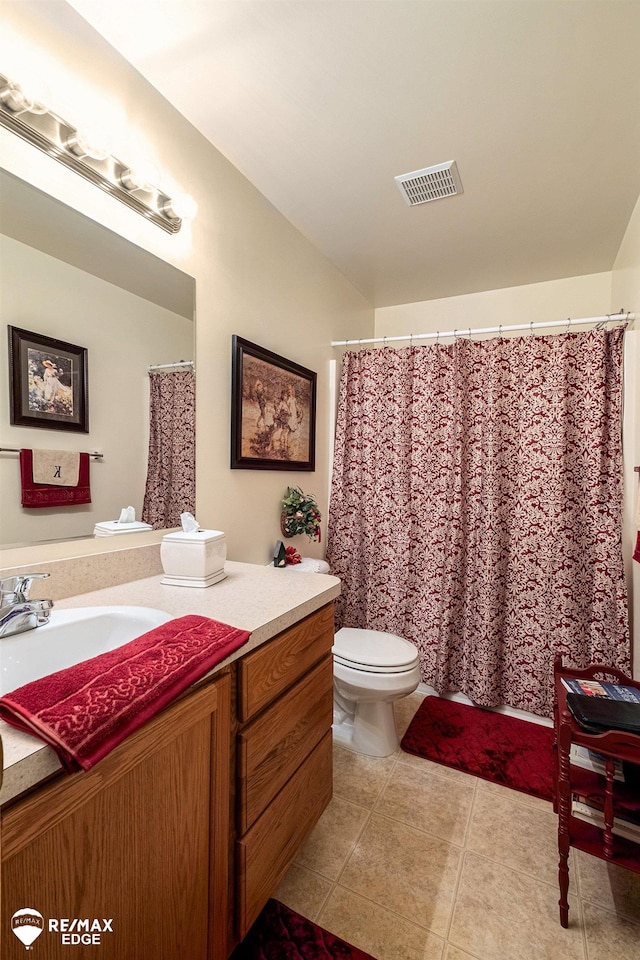 bathroom featuring tile patterned floors, vanity, and toilet