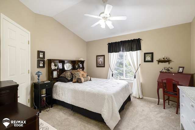 carpeted bedroom with ceiling fan and vaulted ceiling