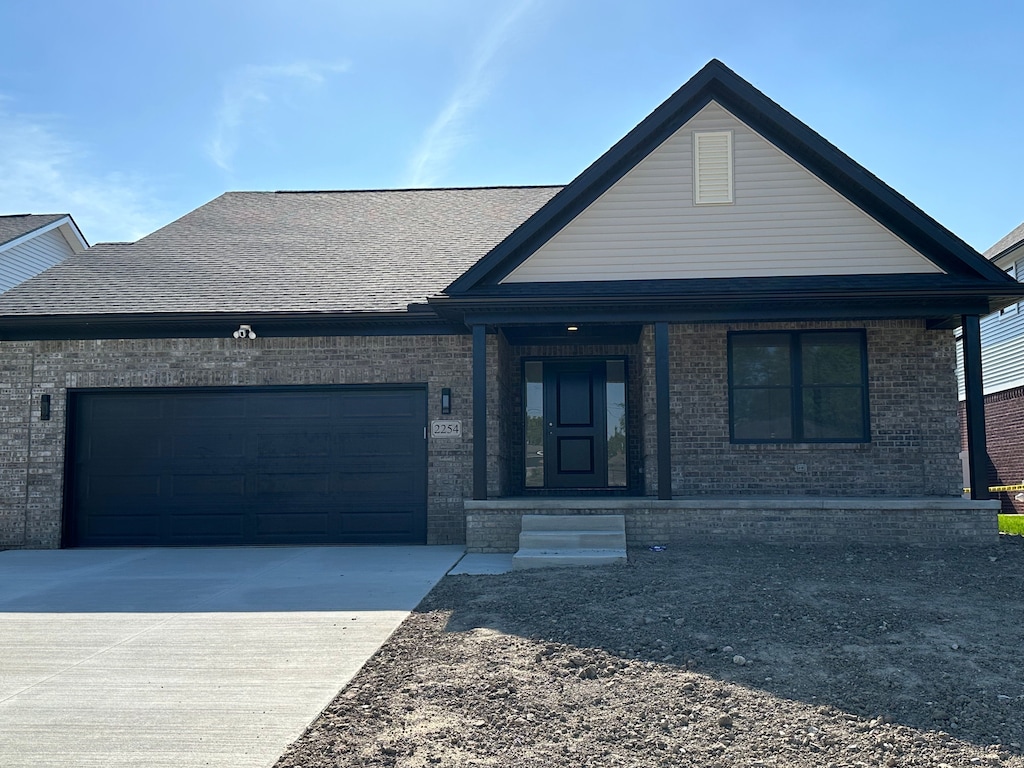 view of front of home with covered porch and a garage