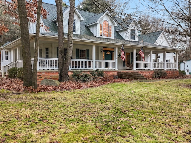 view of front of property featuring covered porch and a front yard