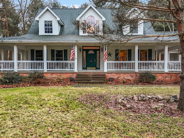 farmhouse-style home featuring a porch and a front lawn