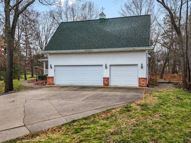 garage featuring a lawn