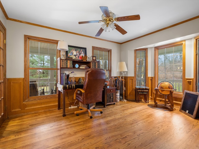 home office featuring a wealth of natural light, light hardwood / wood-style flooring, and ceiling fan