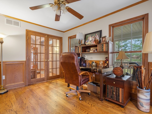 home office featuring crown molding, french doors, ceiling fan, and light hardwood / wood-style floors