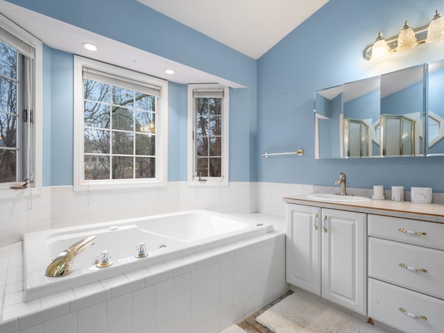 bathroom featuring vanity and plus walk in shower