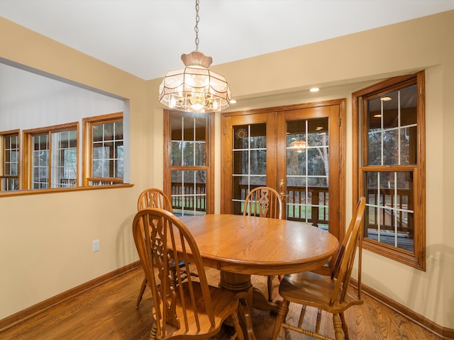 dining room featuring a chandelier, french doors, and wood-type flooring