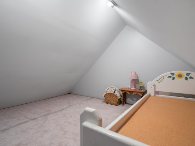 bedroom featuring carpet floors and lofted ceiling