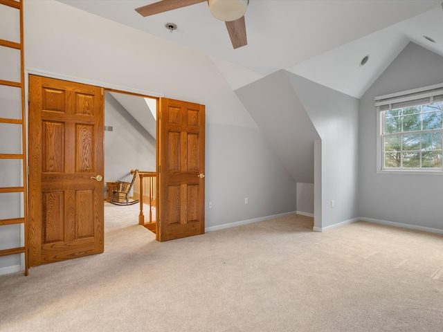 bonus room with ceiling fan, light colored carpet, and vaulted ceiling