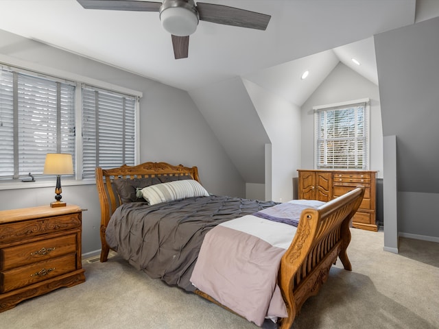 bedroom with light colored carpet, vaulted ceiling, and ceiling fan