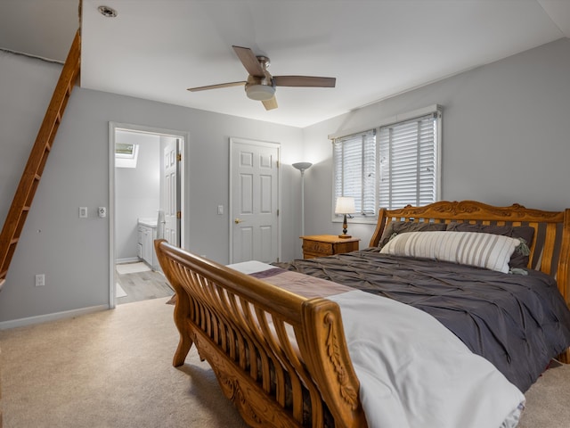 bedroom featuring ensuite bath, ceiling fan, and light colored carpet