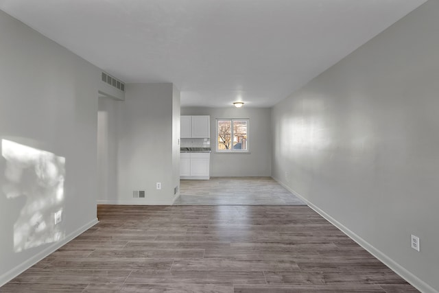 unfurnished living room with light hardwood / wood-style flooring