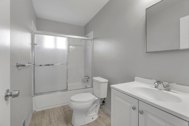 full bathroom with vanity, toilet, and enclosed tub / shower combo