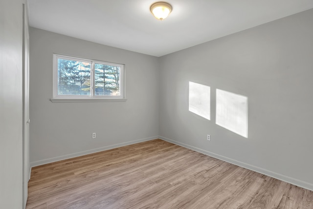 empty room with light hardwood / wood-style floors