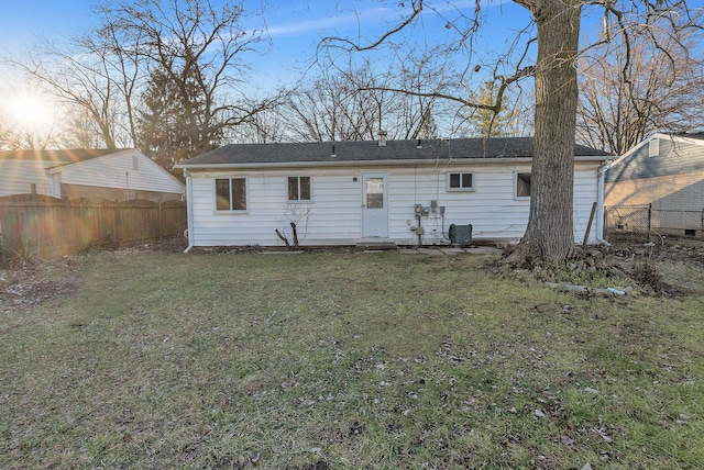 back of house with cooling unit and a yard