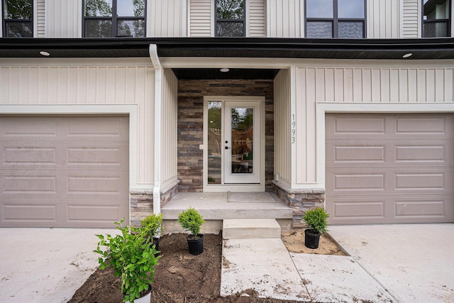 1981 N Shorewood Ln Unit 6, Holland, MI 49423 - doorway to property featuring stone siding, driveway, and an attached garage