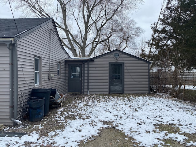 view of snow covered rear of property