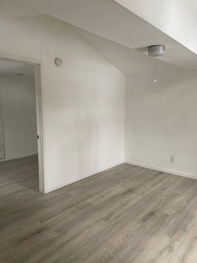 1095 Harding Dr, Grand Blanc, MI 48507 - spare room with wood finished floors, lofted ceiling, and baseboards