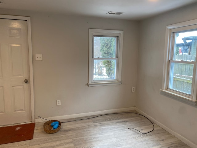 empty room featuring light hardwood / wood-style floors and a healthy amount of sunlight