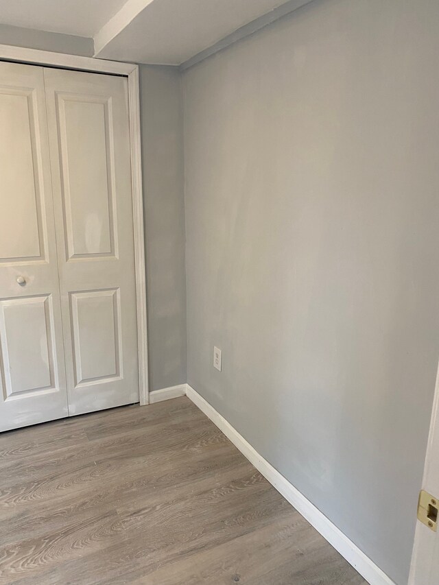 1095 Harding Dr, Grand Blanc, MI 48507 - unfurnished bedroom with wood finished floors, baseboards, and a closet